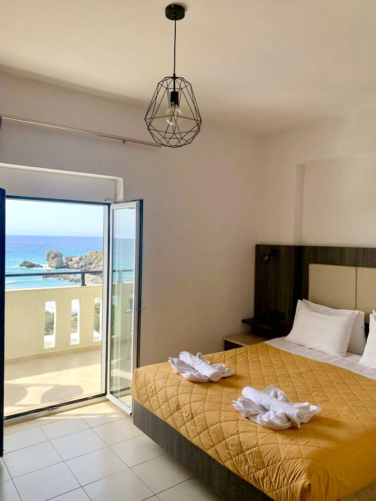 Double room at Virgin Mary Rodakino with balcony door open to the Libyan Sea